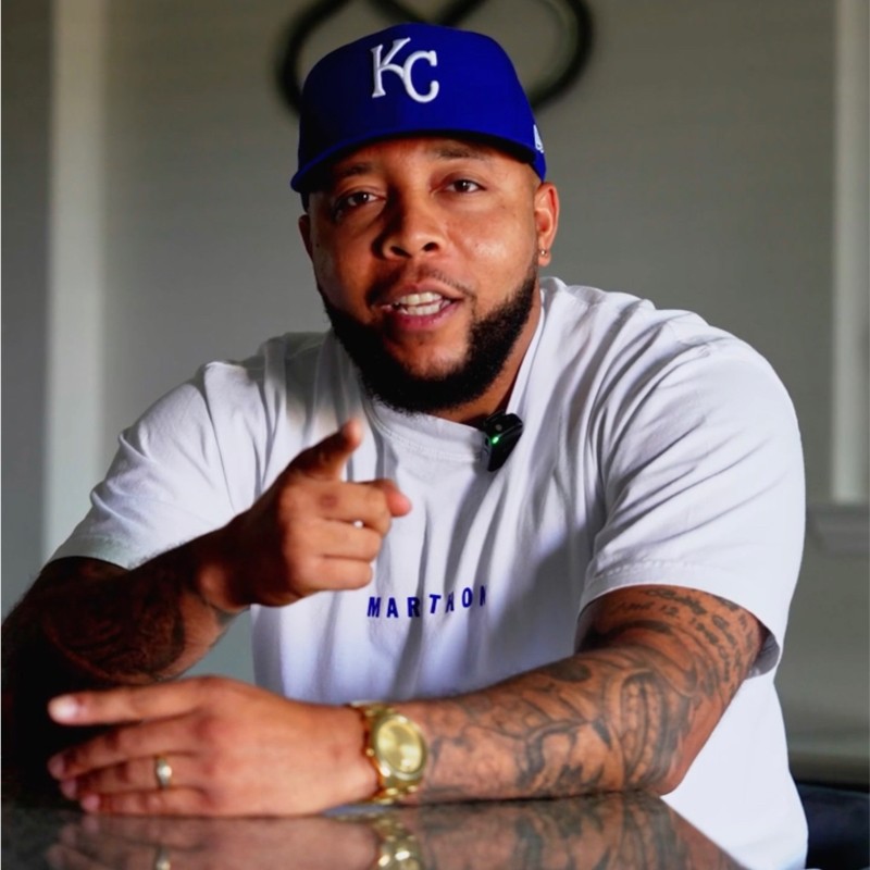 Mychael Anderson speaking directly to camera in his KC cap